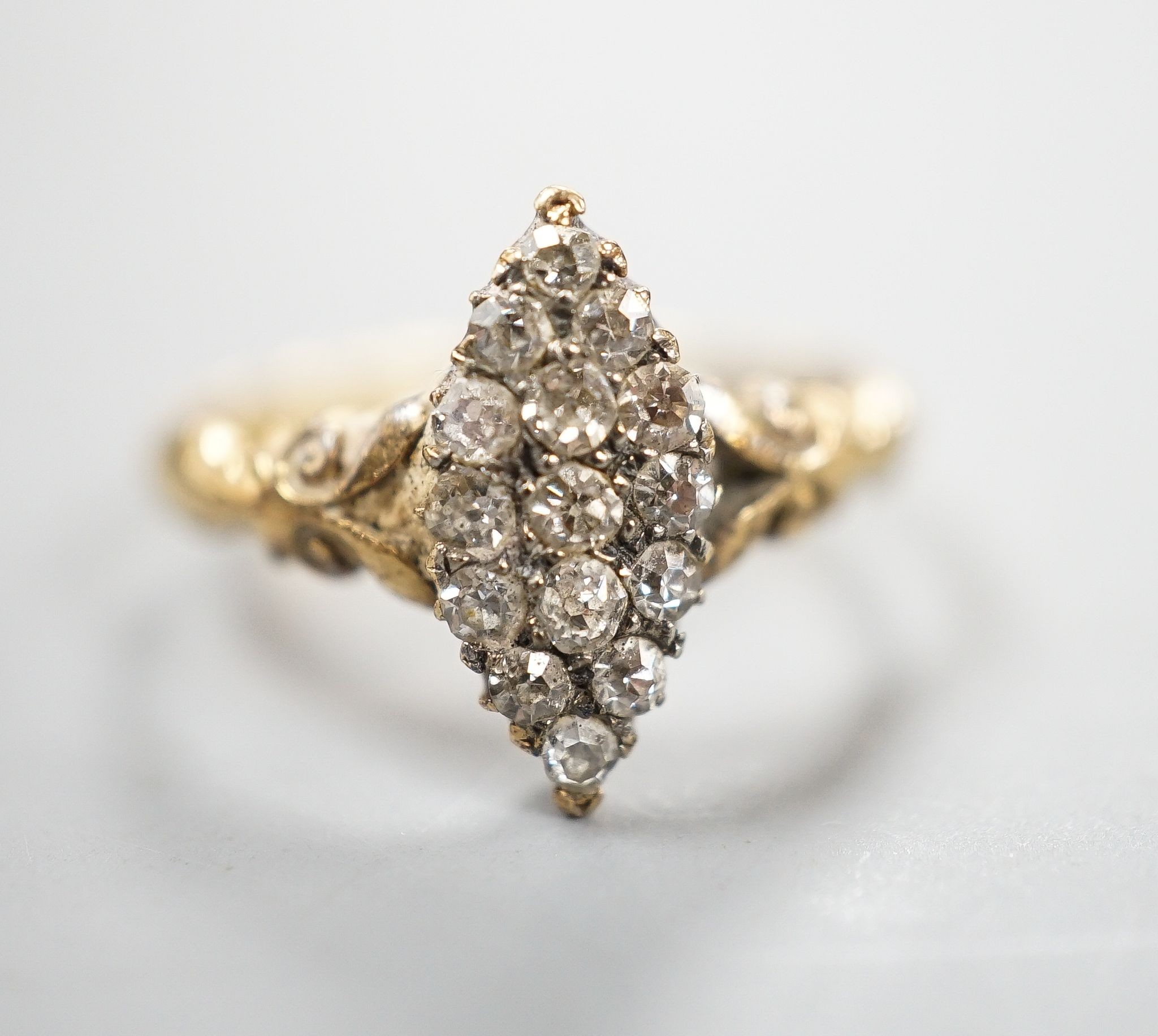 An 18ct and diamond cluster set marquise shaped ring, size K/L, gross 3.2 grams.